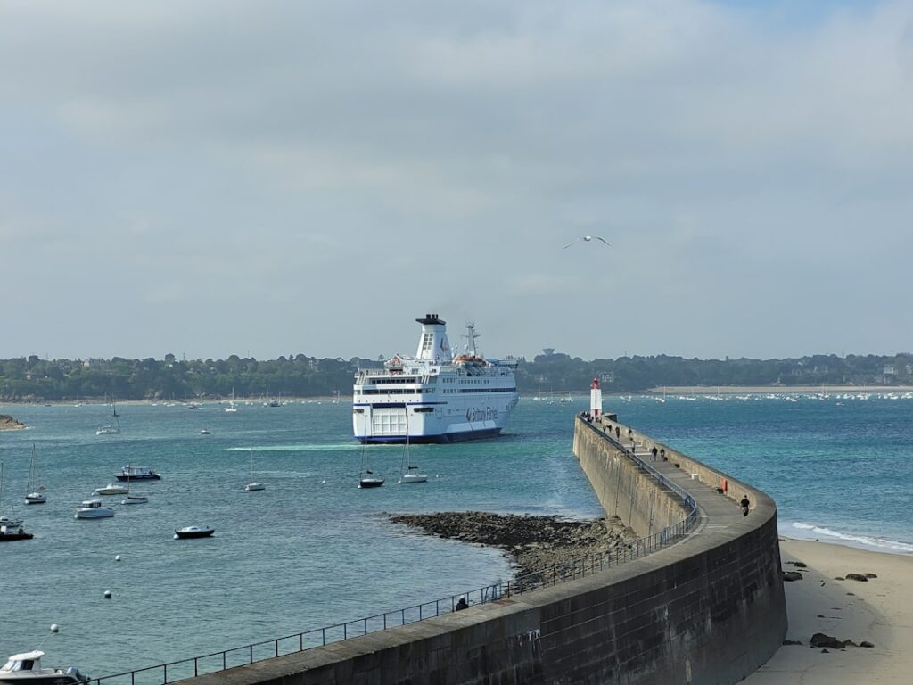 A large ferry departs from the harbor.